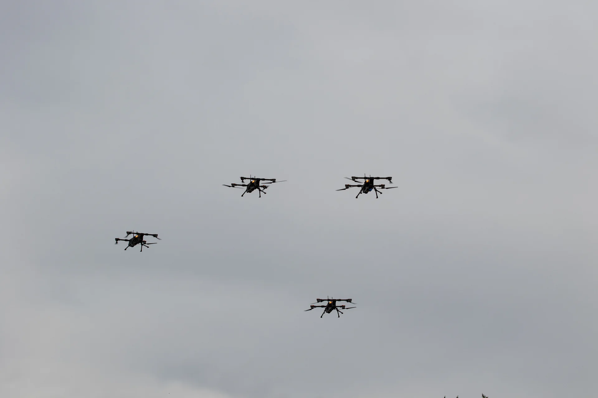 Four counter-drone quadcopters flying in formation